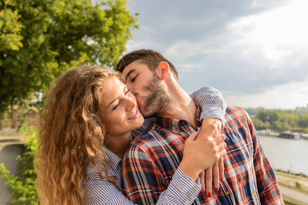 Smiling couple embracing outdoors representing positive results of marriage counseling